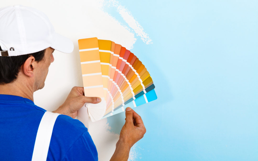painter-looking-at-a-color-palette-on-half-painted-wall-right-paint-concept