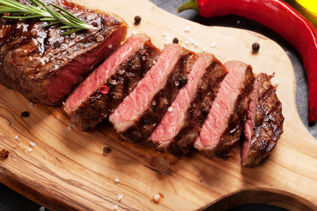 grilled-striploin-sliced-steak-on-cutting-board