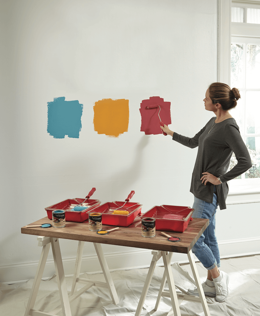 woman sampling paint with roller brush
