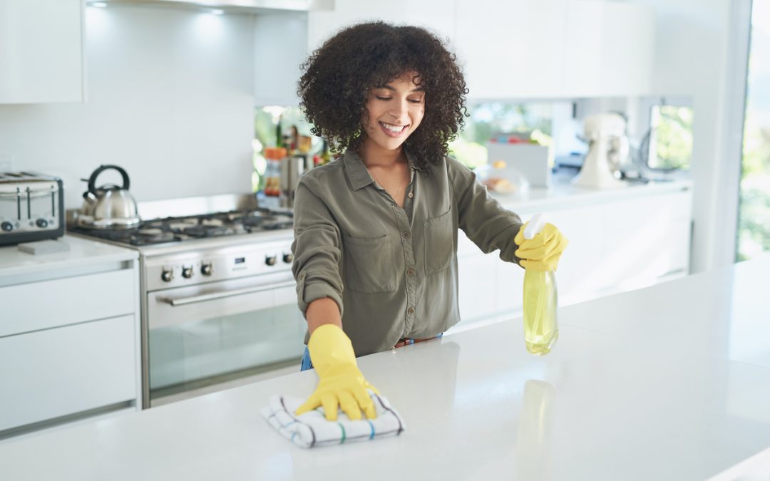 woman-cleaning-a-kitchen-counter-at-home