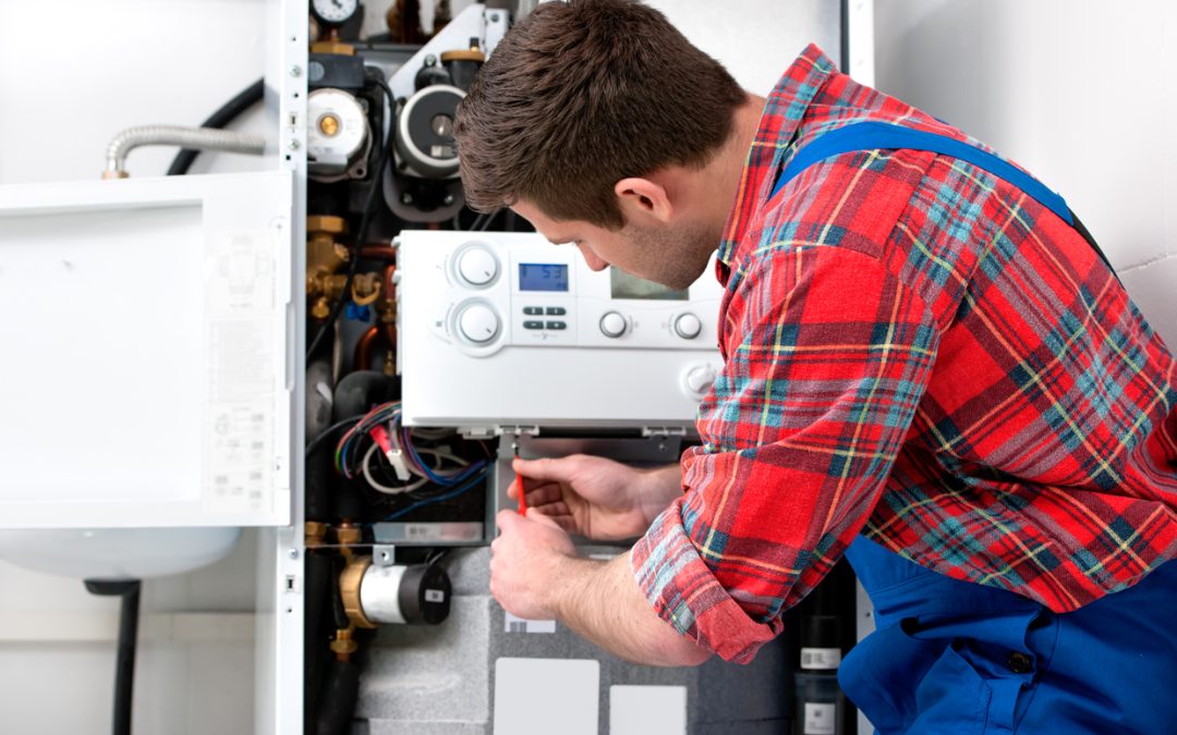 male-technician-fixing-a-heating-system-heating-related-fires-concept